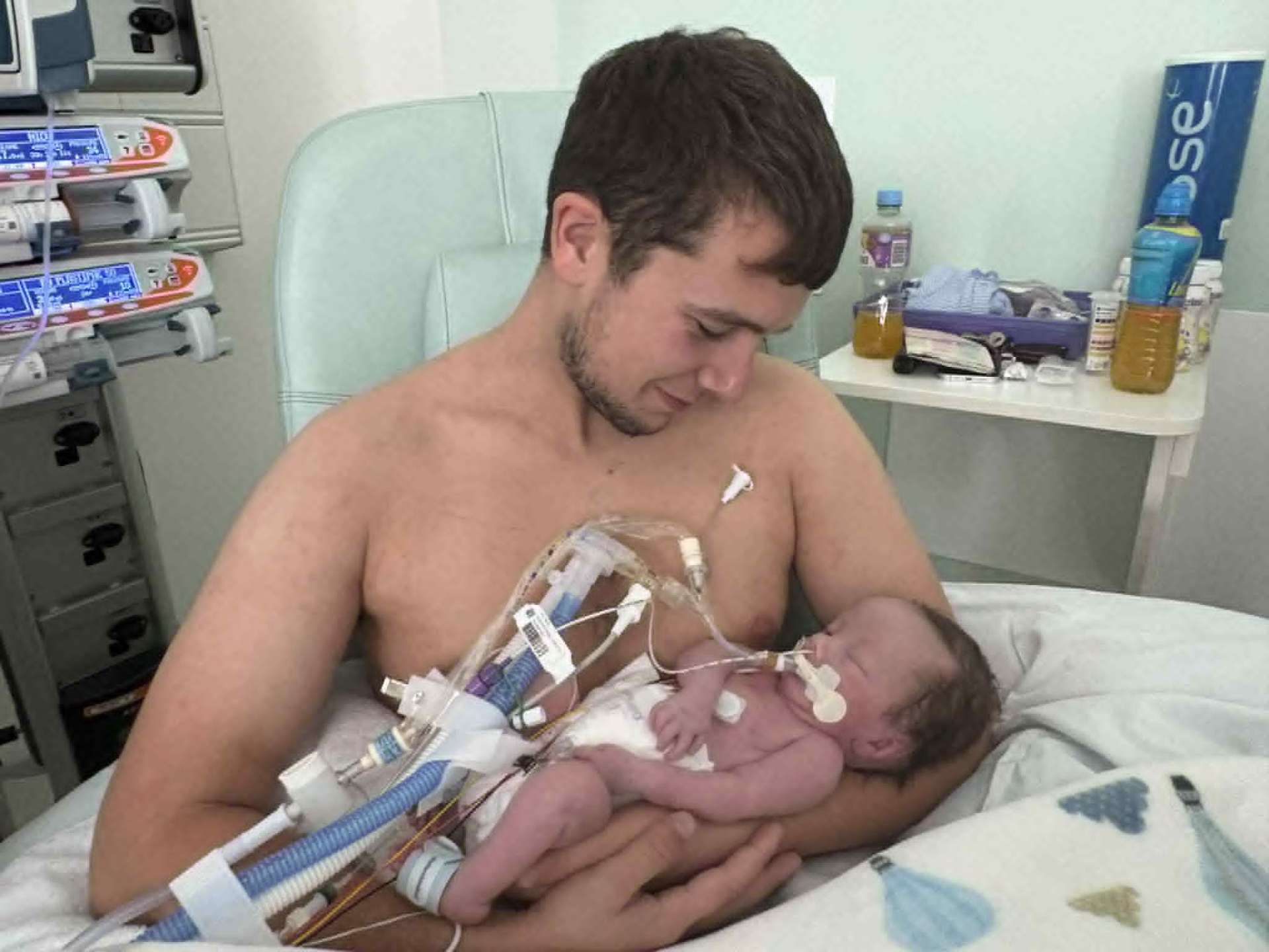 Father holding Noah skin-to-skin in NICU