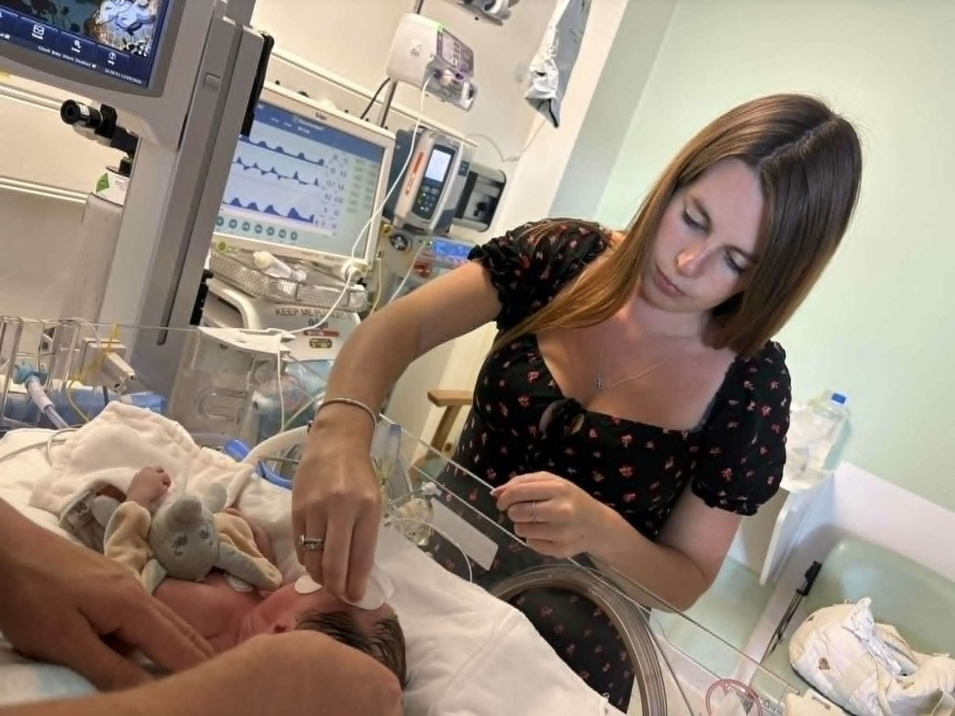 Mother tending to Noah in the incubator