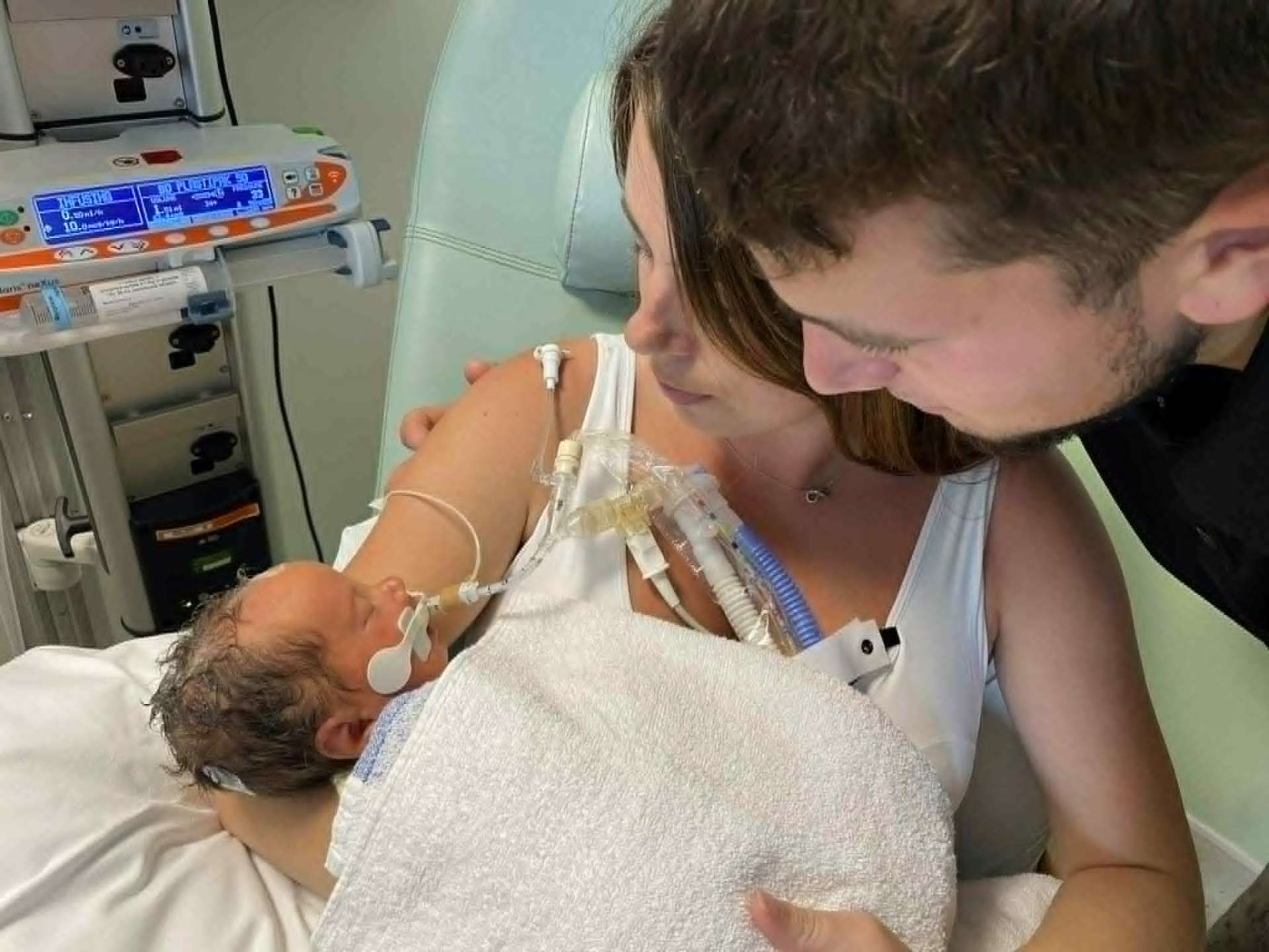 Both parents holding Noah on Mum's chest