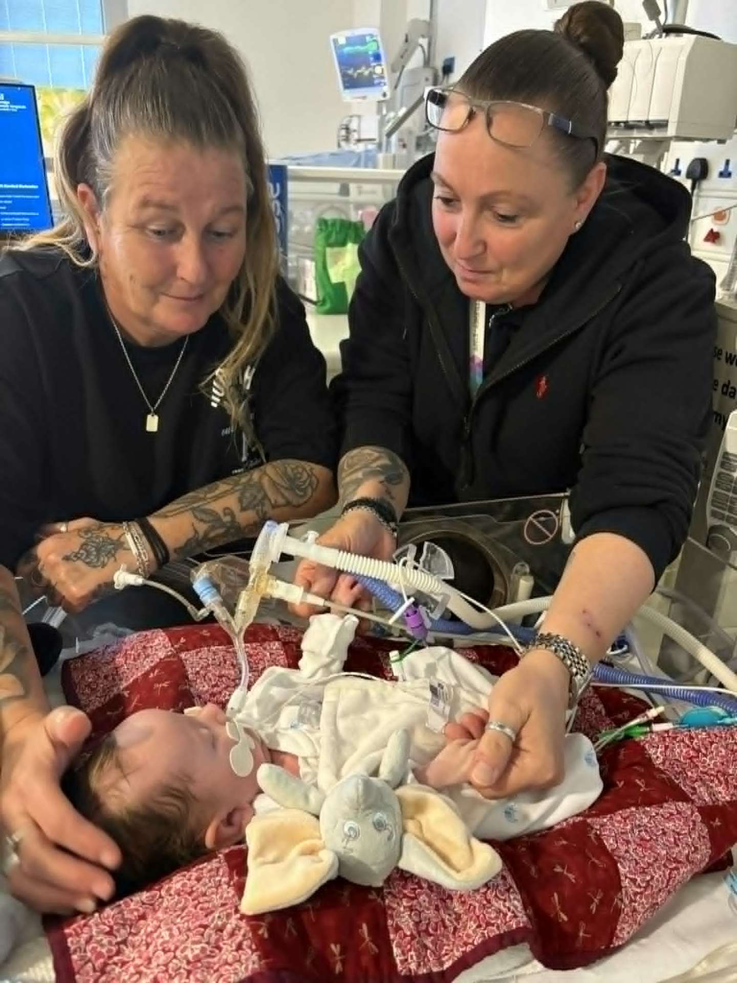 Family gathered around Noah's incubator